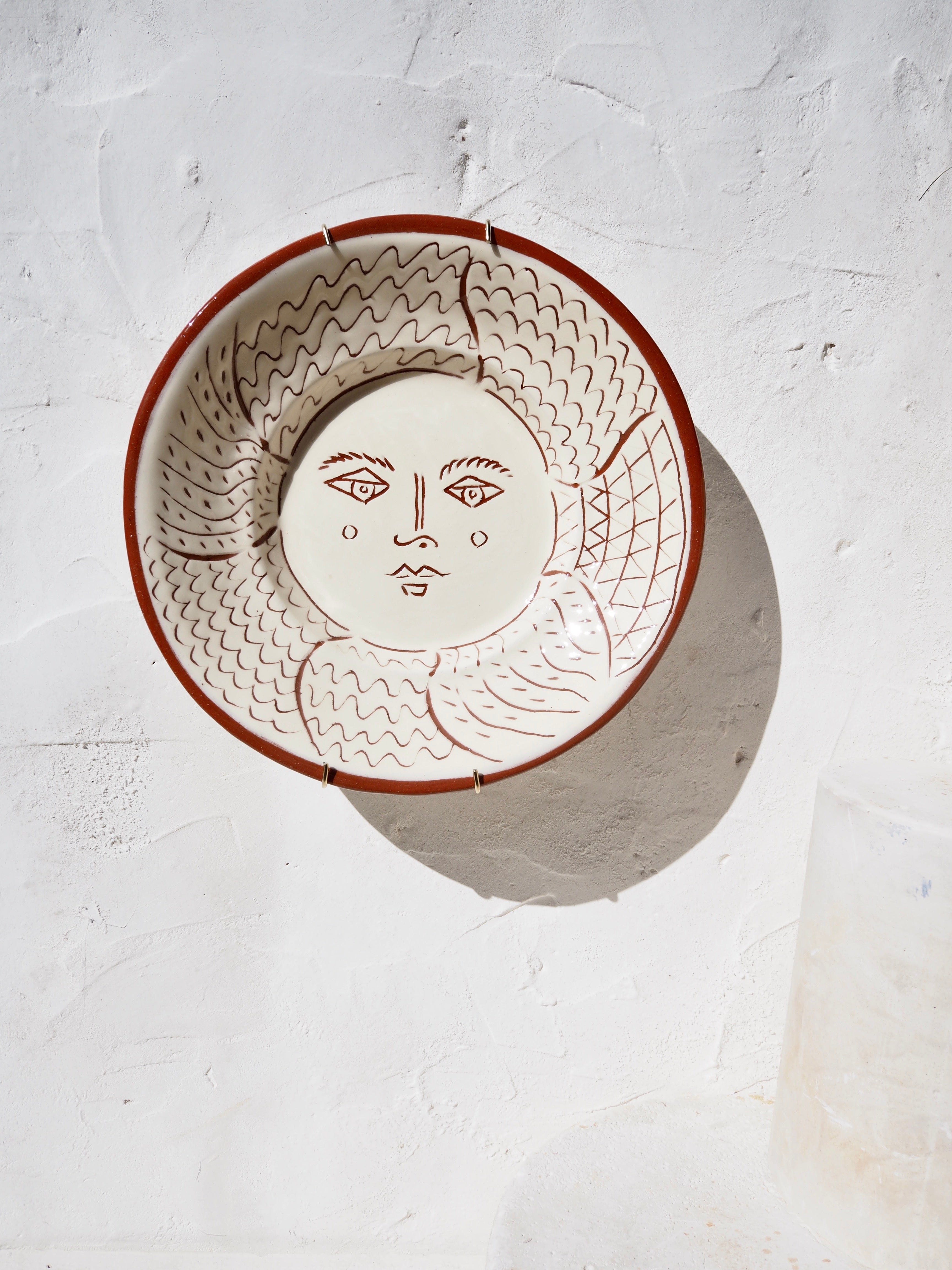 Puglia Plate - Hand carved Il sole face with brass wall hook
