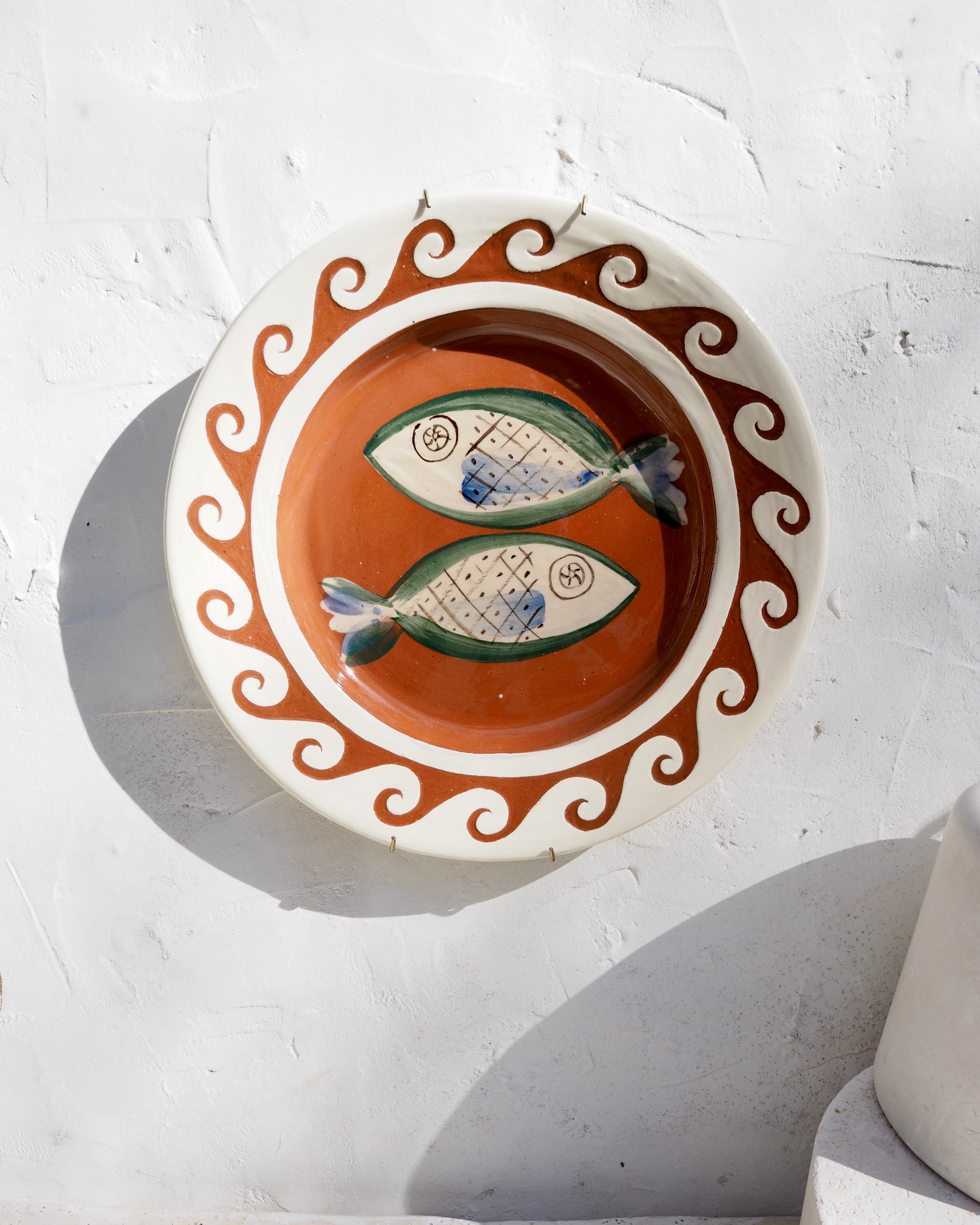 Plate with carved sgraffito wave border and fish design