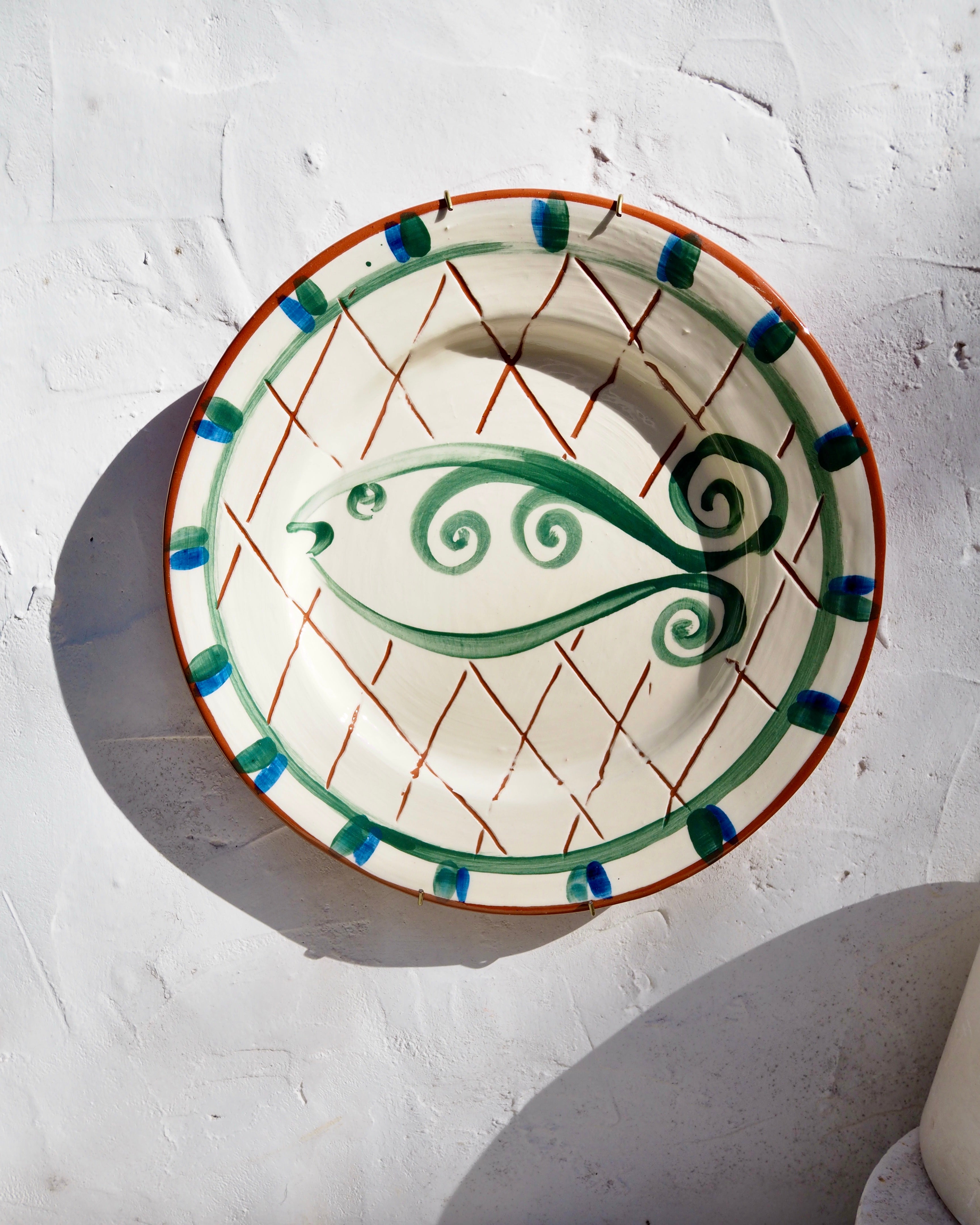 Plate with carved sgraffito and fish design