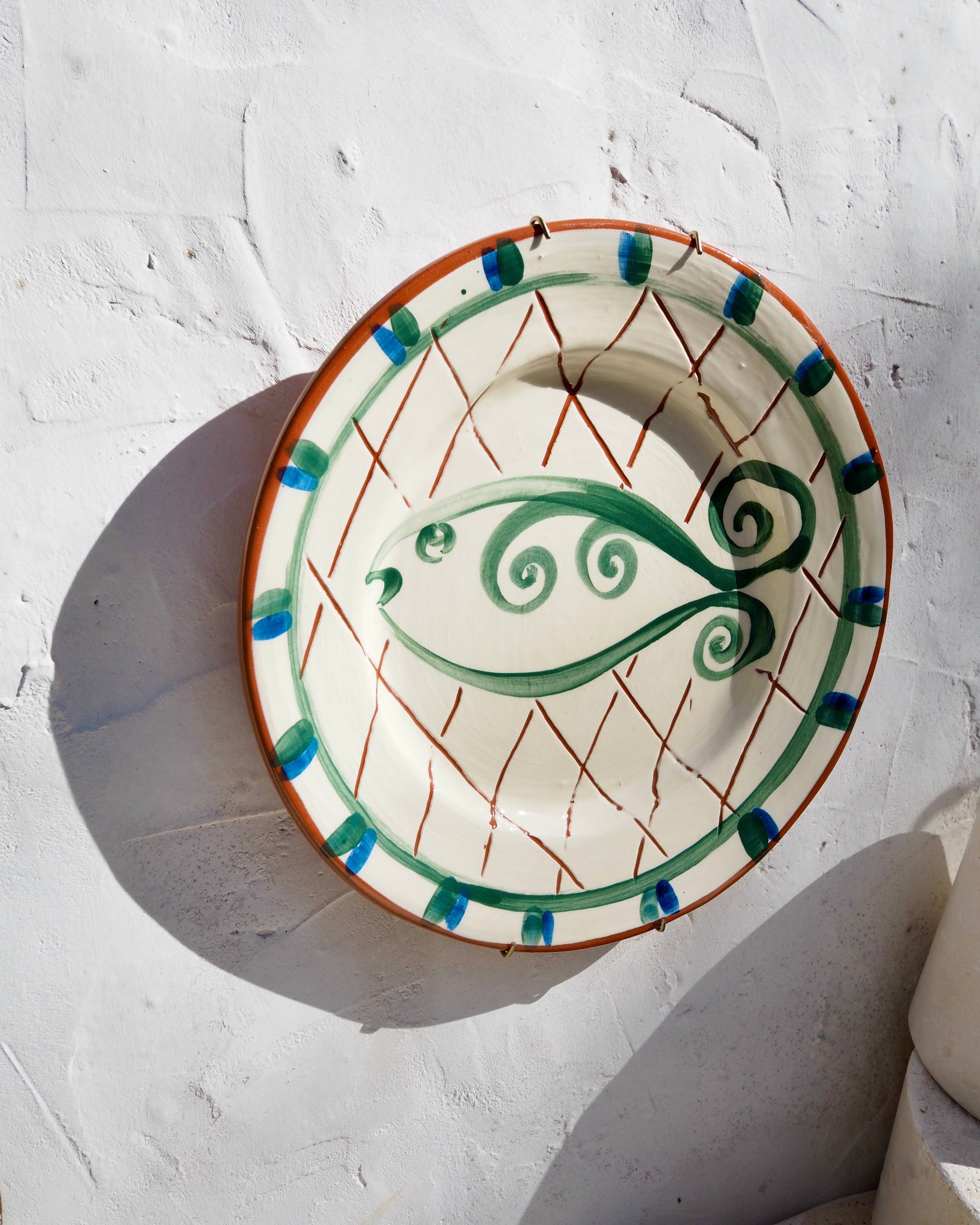 Plate with carved sgraffito and fish design