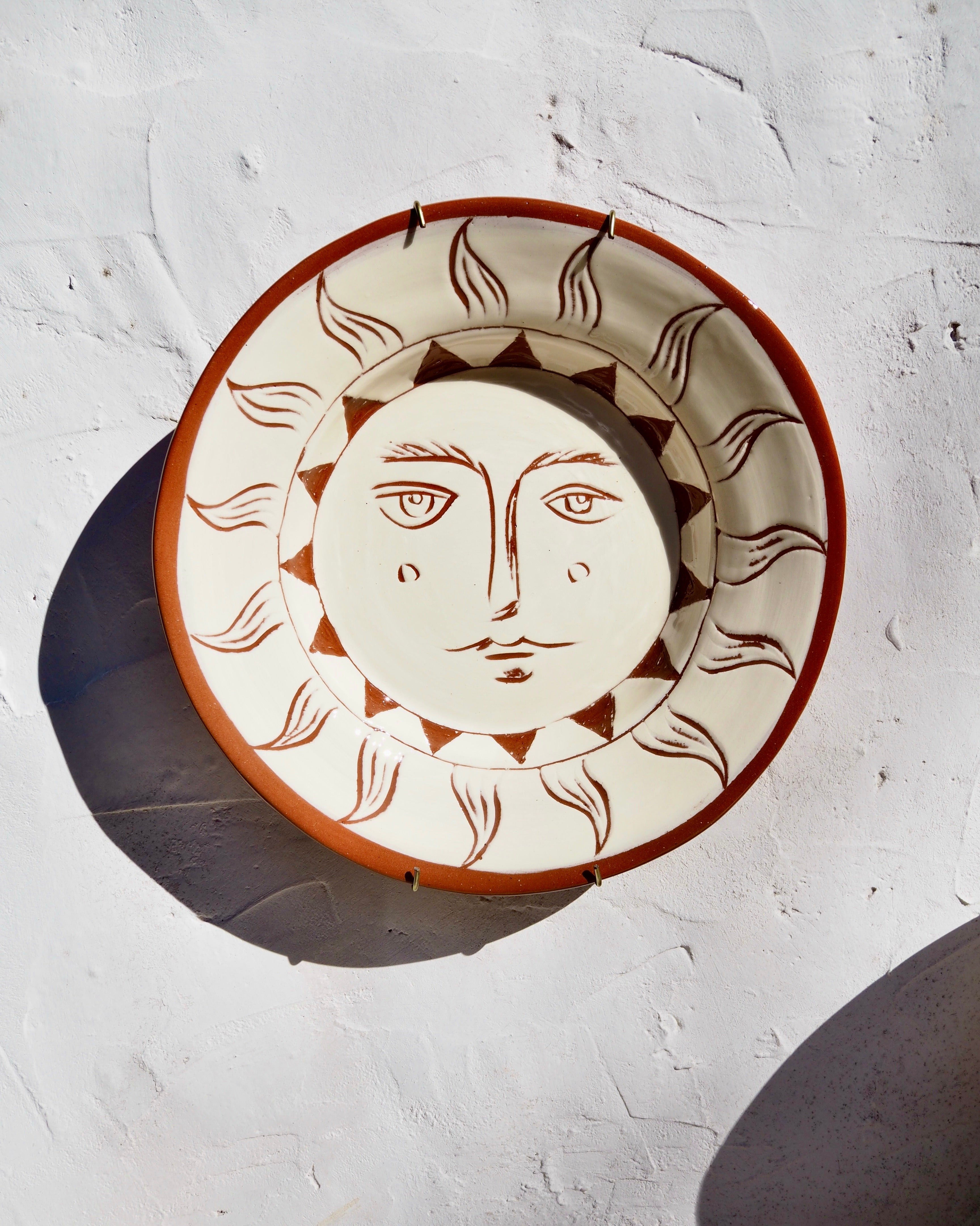 Puglia Plate - Hand carved Il sole face with brass wall hook