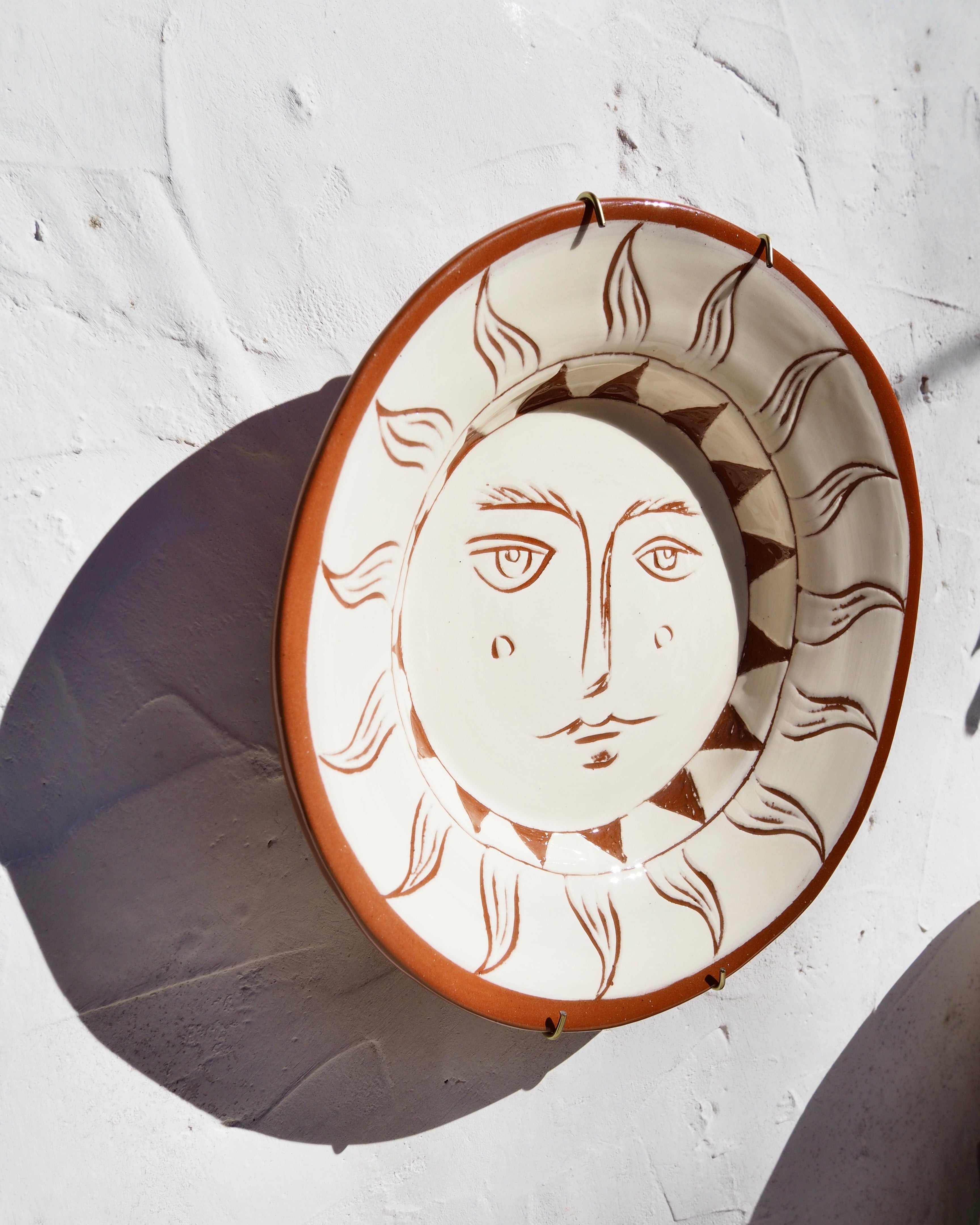 Puglia Plate - Hand carved Il sole face with brass wall hook
